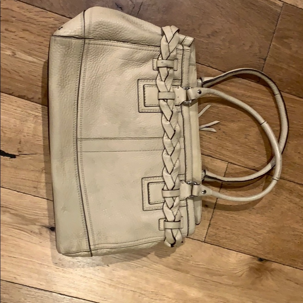 A beige coach bag